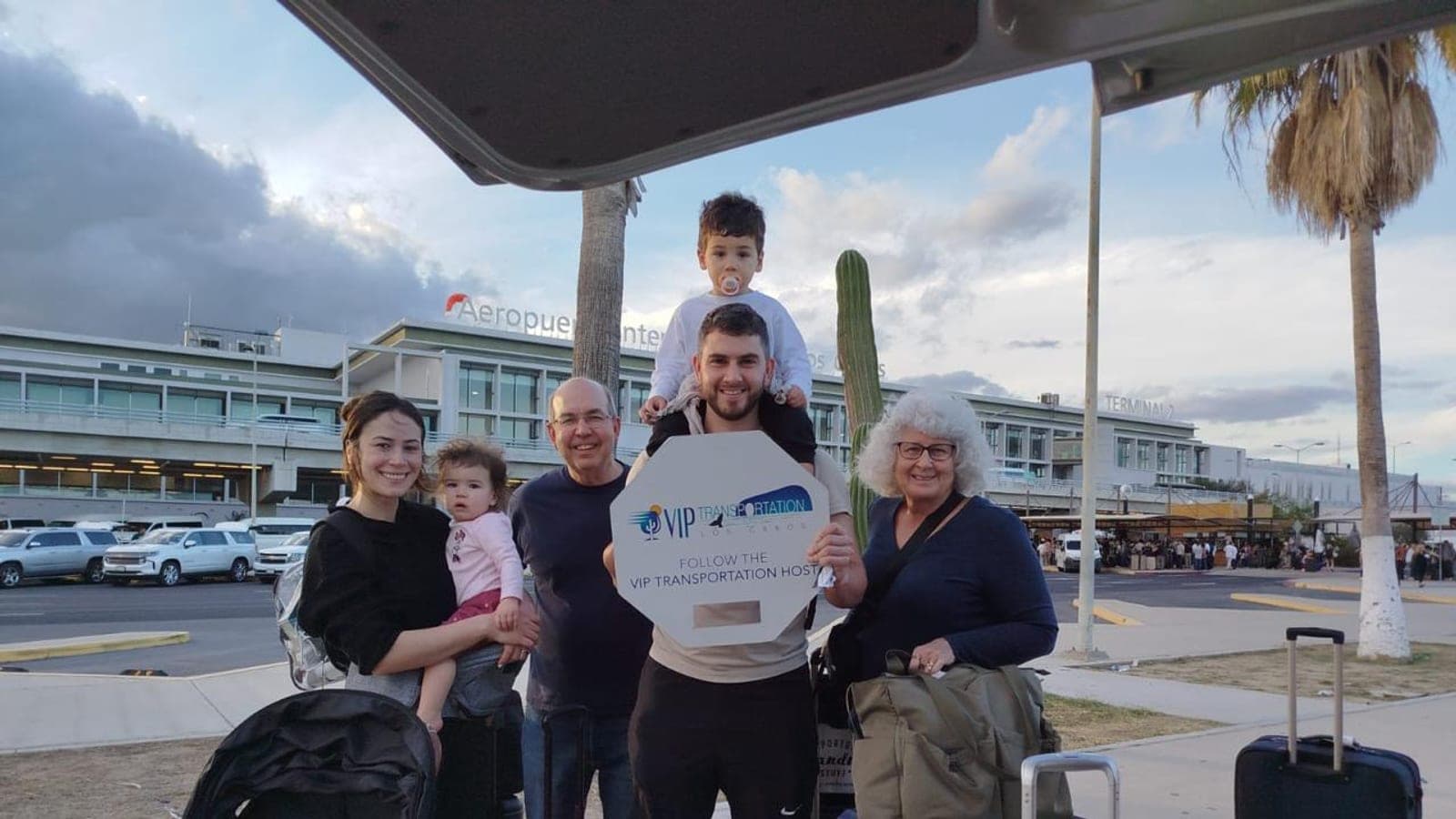 Three generations with a baby and toddler at the airport